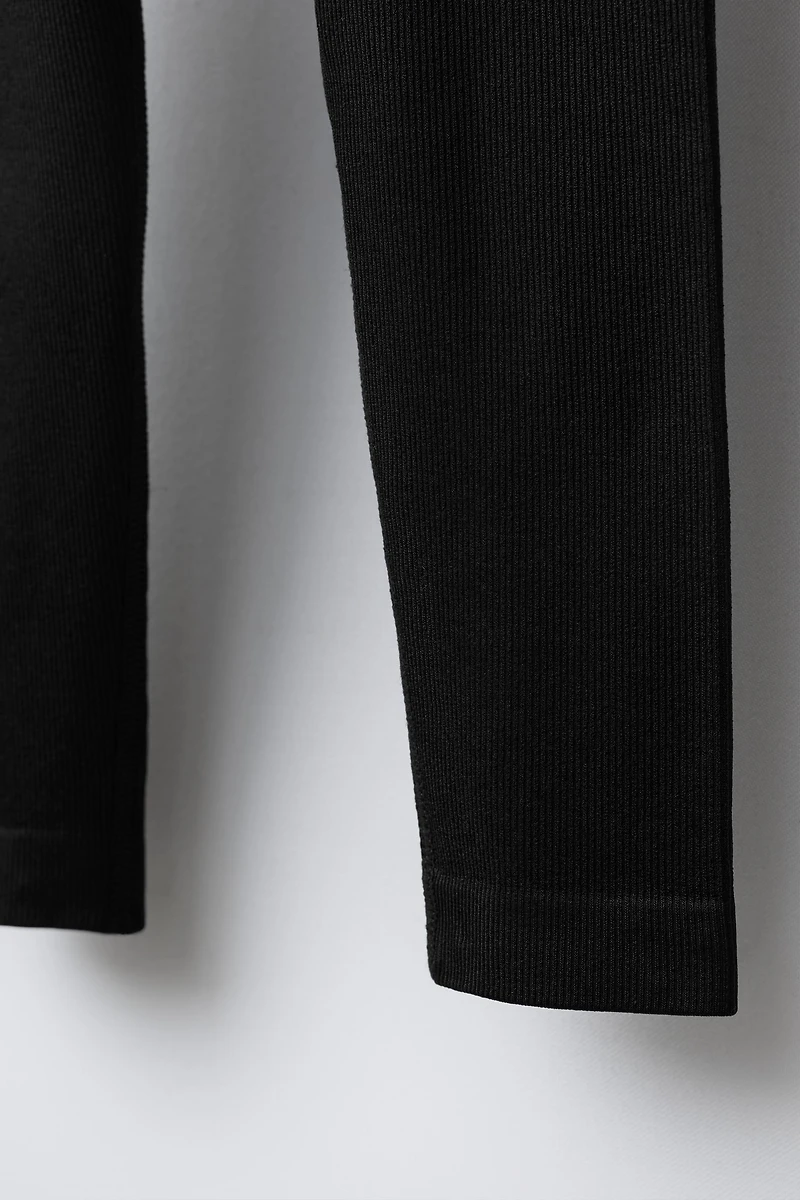 EMBOSSED TEXT RIBBED LEGGINGS