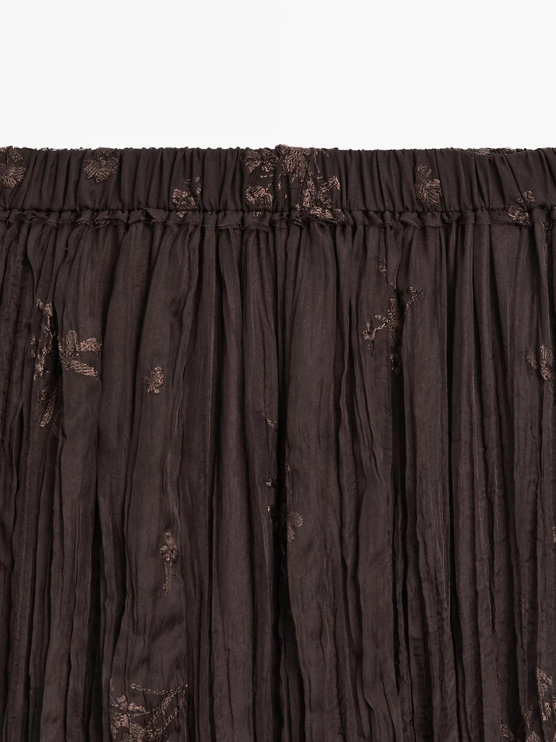 Long pleated skirt with embroidered detail