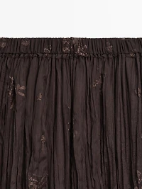 Long pleated skirt with embroidered detail