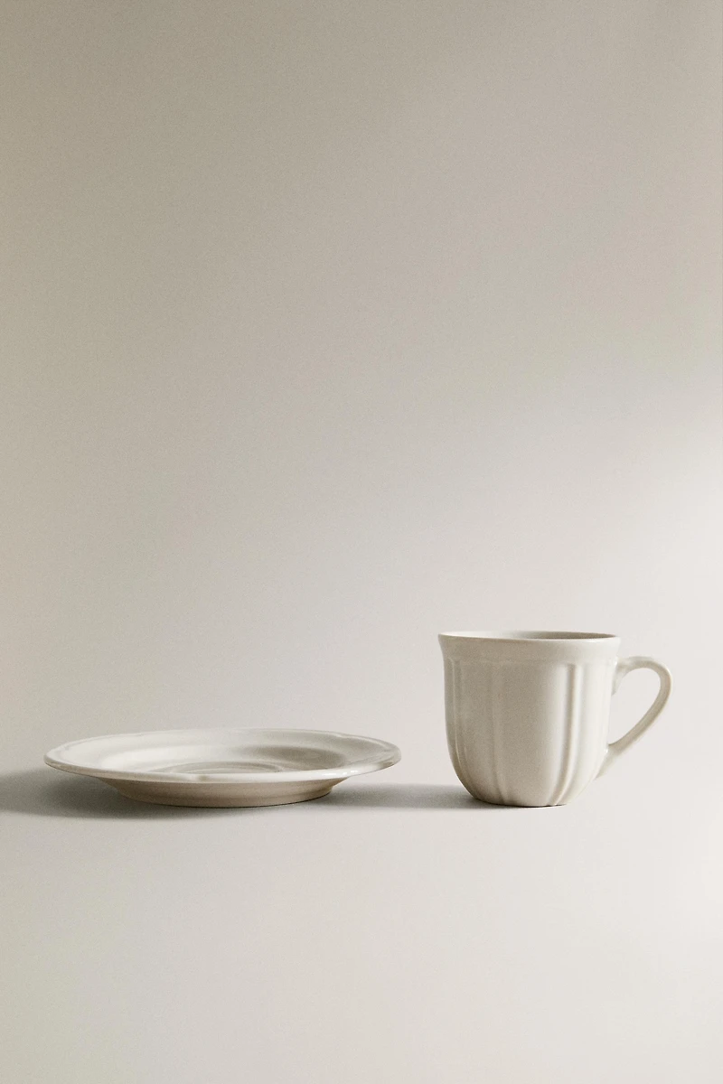 COFFEE CUP AND PORCELAIN SAUCER WITH RAISED DESIGN