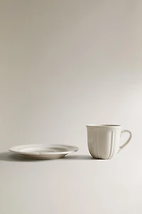 COFFEE CUP AND PORCELAIN SAUCER WITH RAISED DESIGN