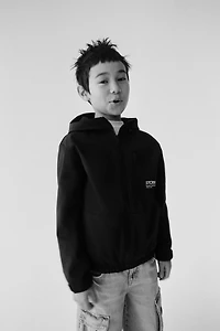 VESTE TECHNIQUE DOUBLÉE CAPUCHE DÉPERLANTE