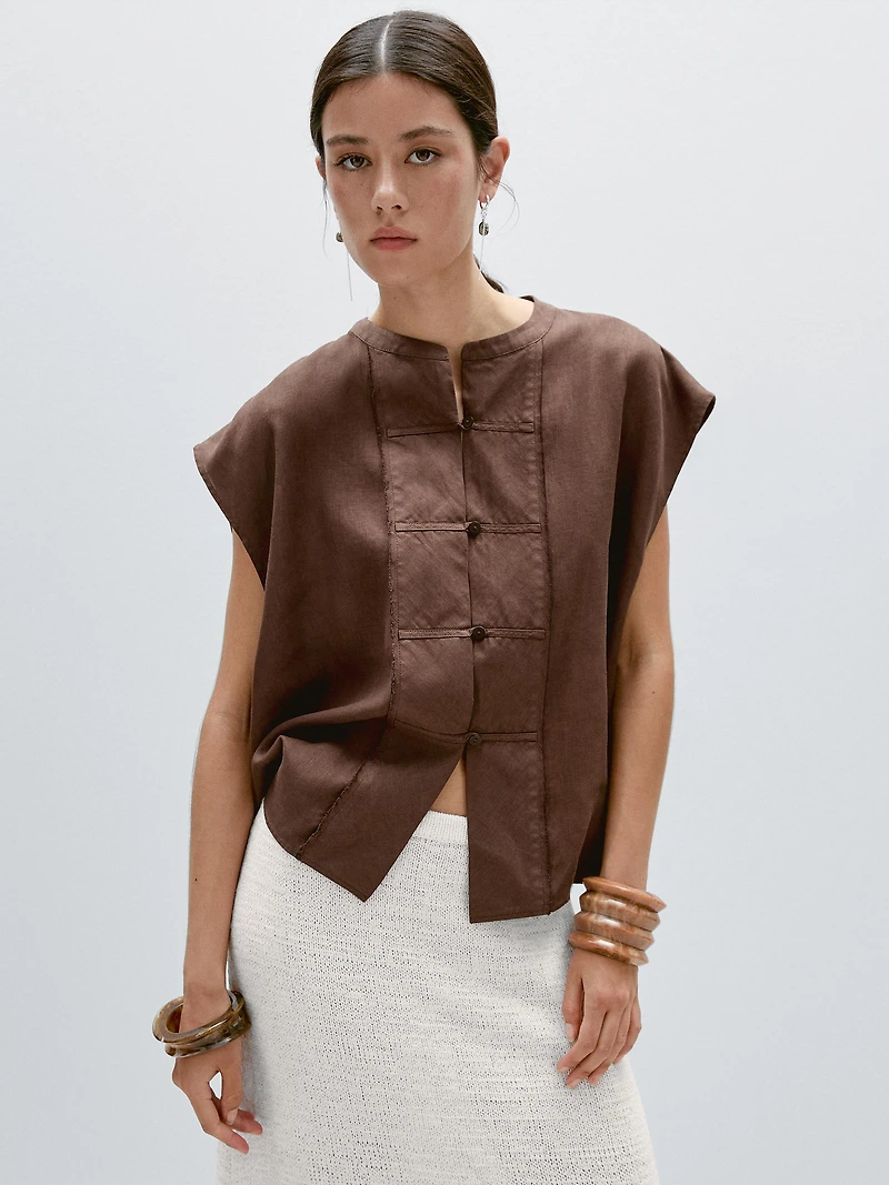 Veste sans manches plastron boutonné