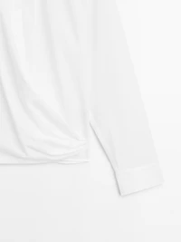 100% cotton shirt with draped asymmetric hem