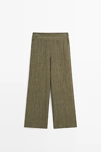 Total look linen trousers with corset belt detail