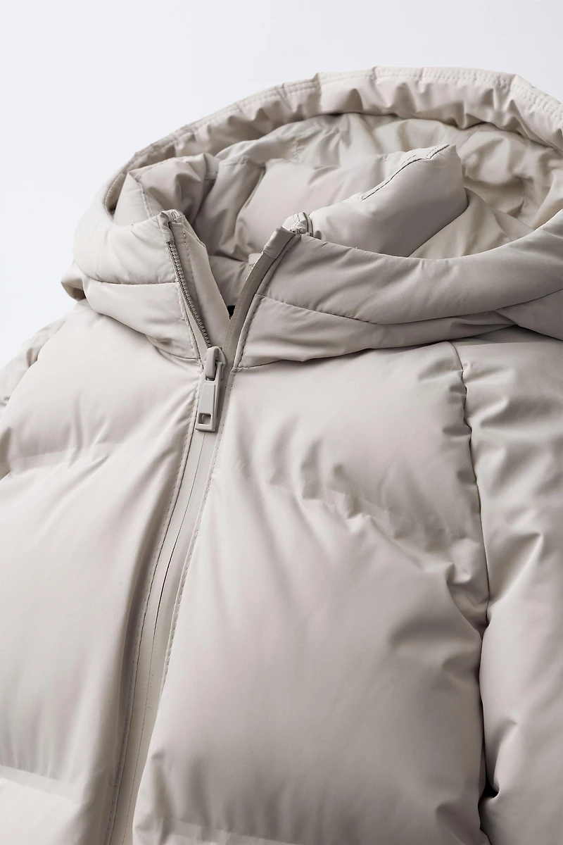 MANTEAU AVEC ÉTIQUETTE AUTOCOLLANTE DÉPERLANT