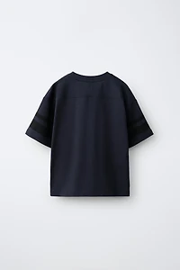 T-SHIRT AVEC PIÈCE NUMÉRO