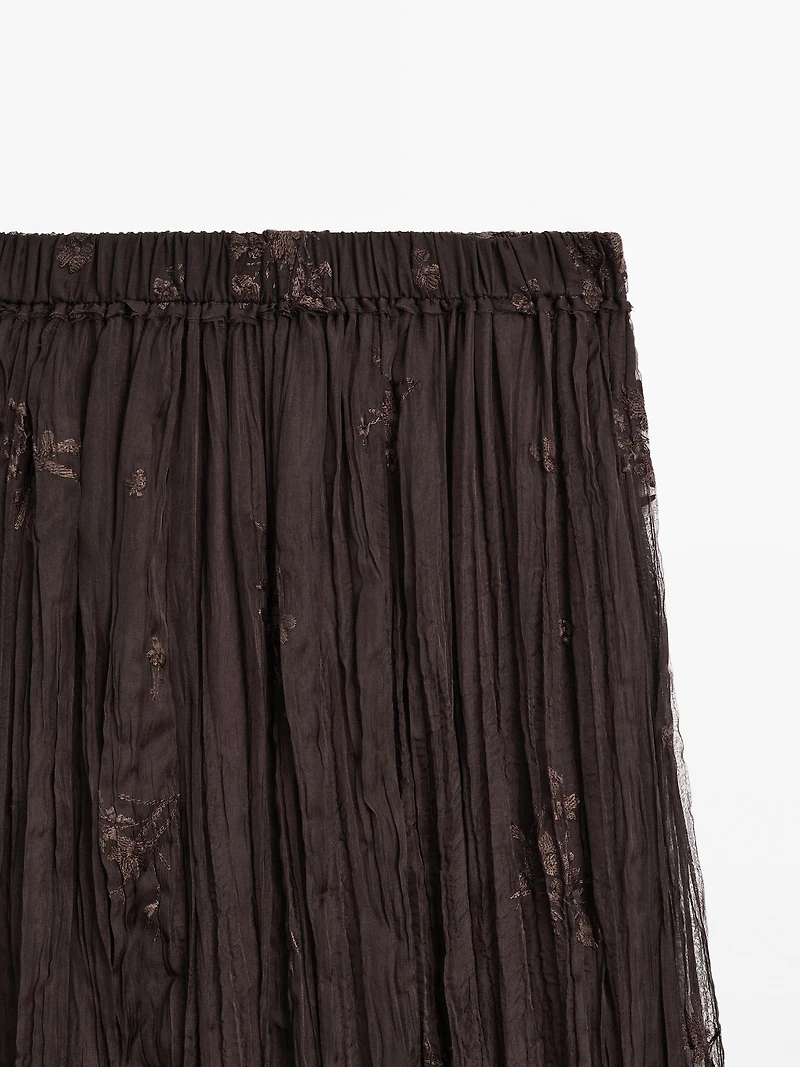 Long pleated skirt with embroidered detail