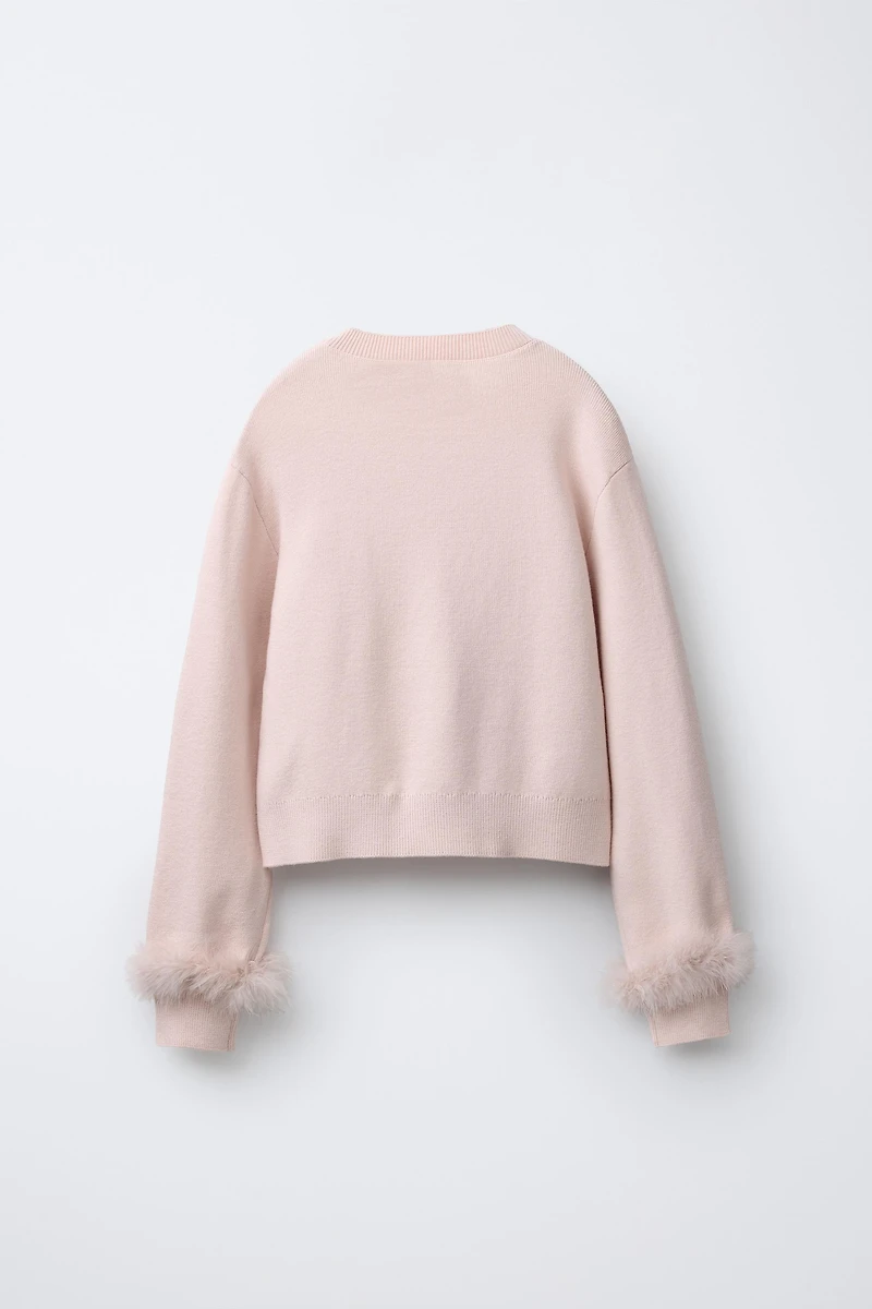 PULL EN MAILLE À PLUMES