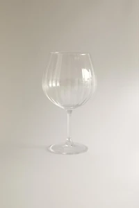 CRYSTALLINE GLASS WITH A RAISED DESIGN