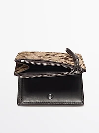 Animal print hair on leather wallet