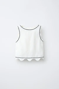 SCALLOPED TOP WITH CONTRAST PIPING