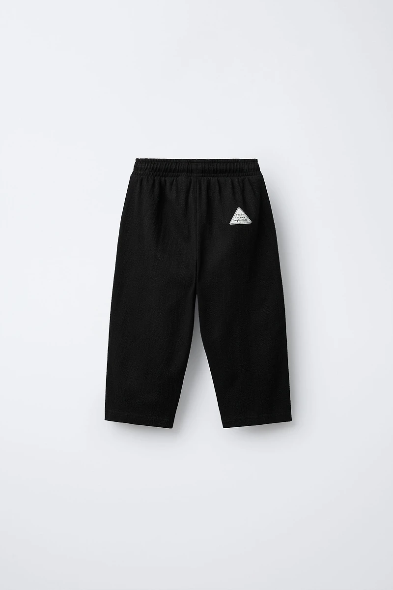 TEXTURED PANTS WITH LABEL