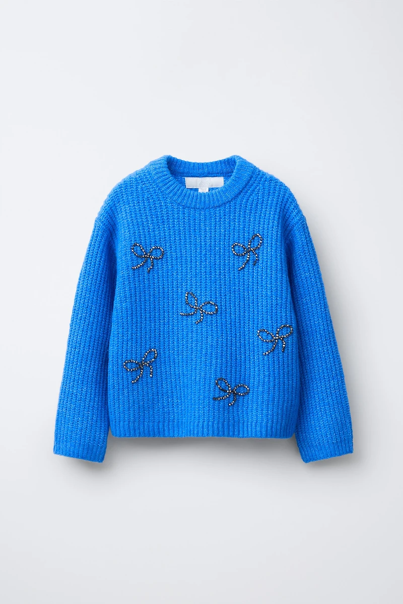 PULL EN MAILLE AVEC ORNEMENTS FANTAISIE LACETS BRILLANTS