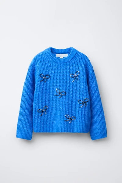 PULL EN MAILLE AVEC ORNEMENTS FANTAISIE LACETS BRILLANTS