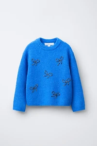 PULL EN MAILLE AVEC ORNEMENTS FANTAISIE LACETS BRILLANTS