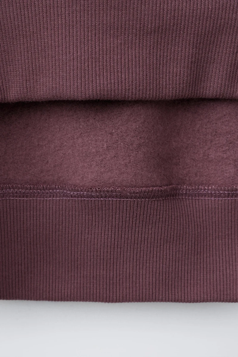 RAISED TEXT SWEATSHIRT