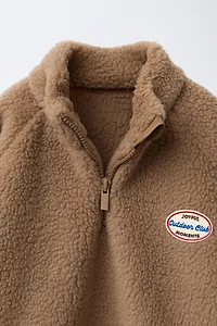 FAUX SHEARLING LABEL SWEATSHIRT