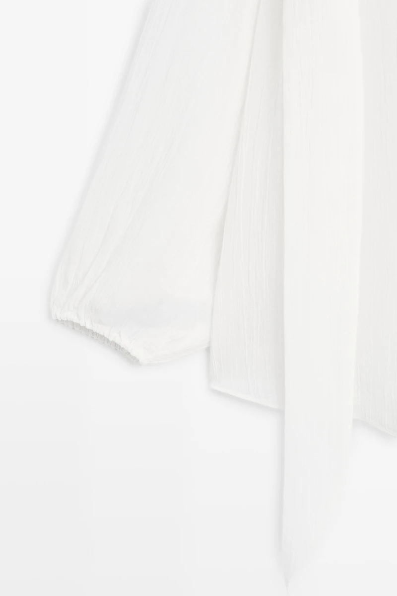 Flowing V-neck blouse with tie