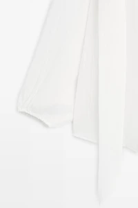 Flowing V-neck blouse with tie
