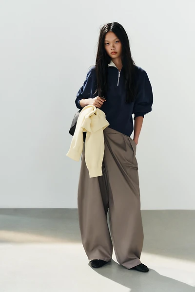 ASYMMETRIC WAIST PLEATED TROUSERS