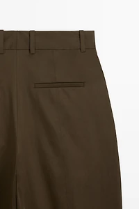 Pants with buttoned hem detail