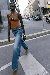 CUT OUT KNIT TOP WITH METAL DETAIL