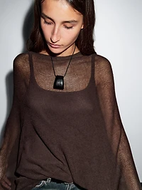 Cape en maille coupe asymétrique