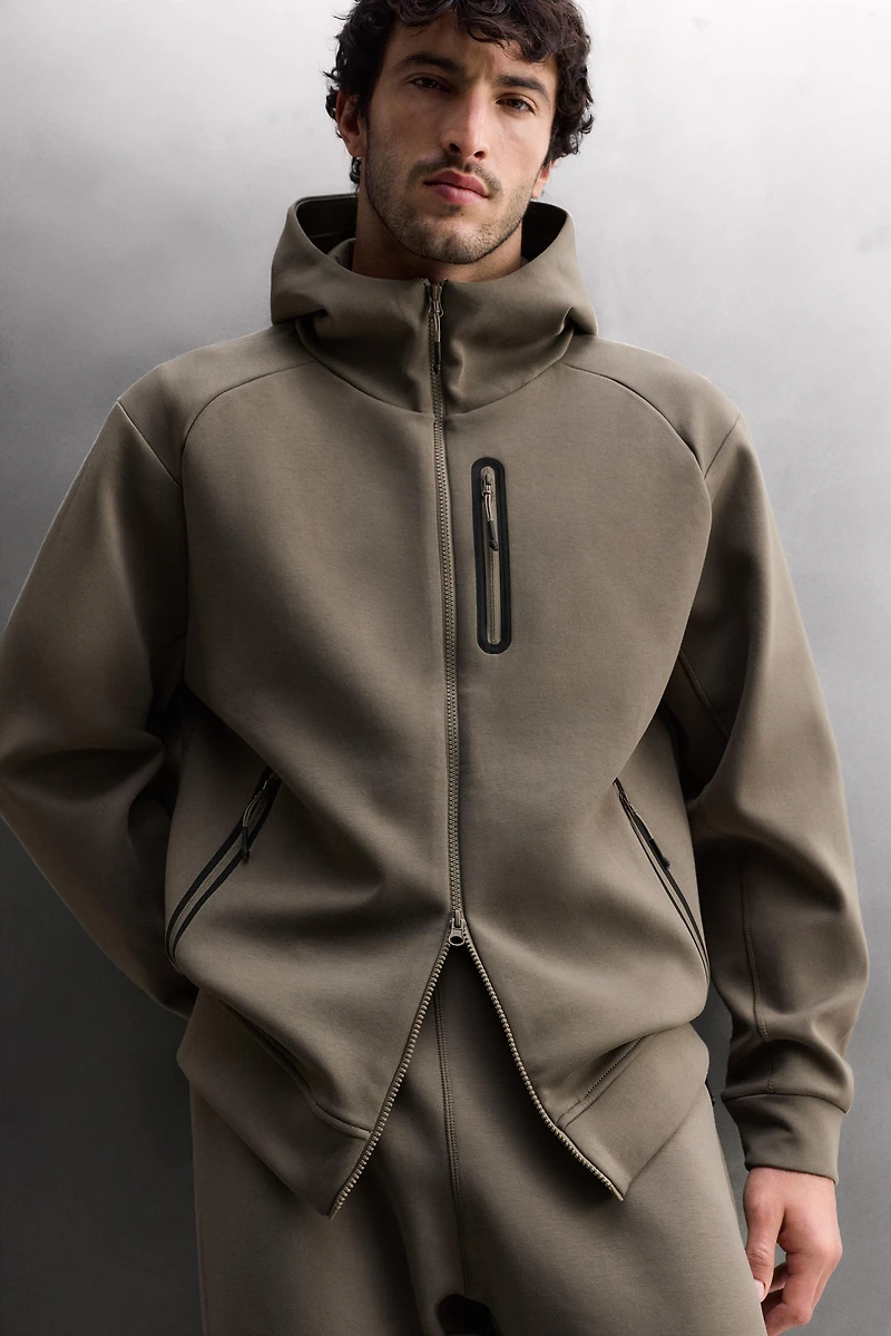 SWEAT TECHNIQUE ZIPPÉ À CAPUCHE