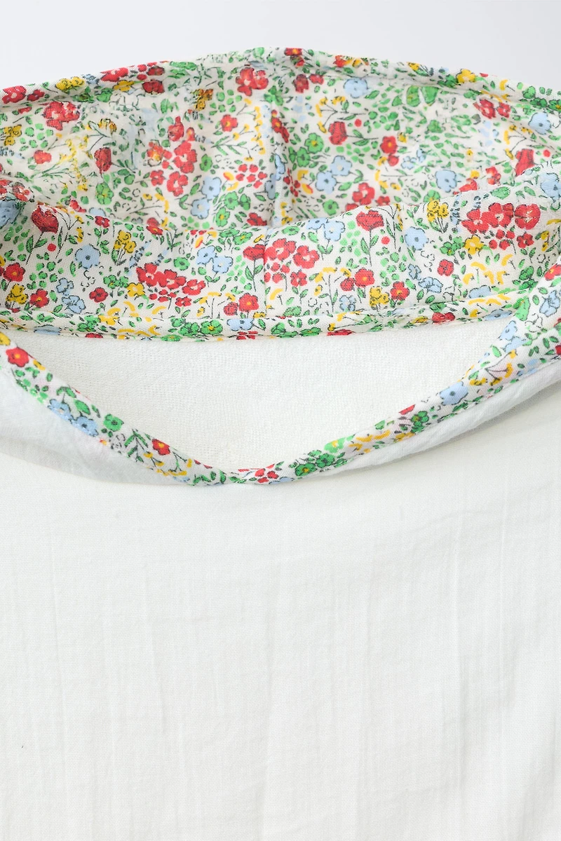 TEXTURED TOWEL PONCHO WITH FLORAL TRIM