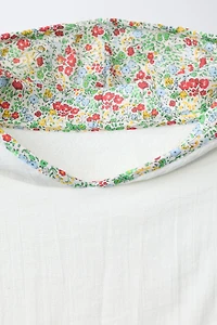 TEXTURED TOWEL PONCHO WITH FLORAL TRIM