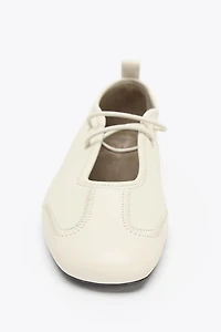 BALLERINES EN CUIR AVEC SURPIQÛRES