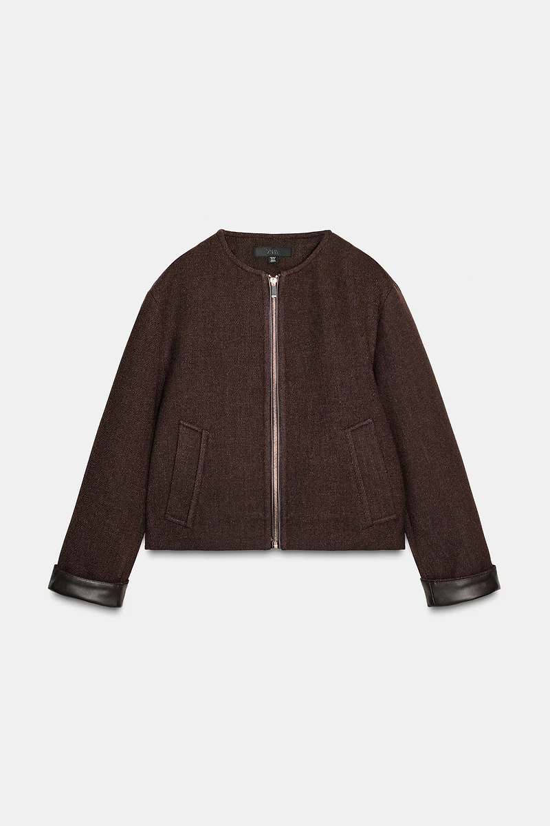 VESTE DOUCE AVEC FINITIONS EN MATIÈRE SYNTHÉTIQUE