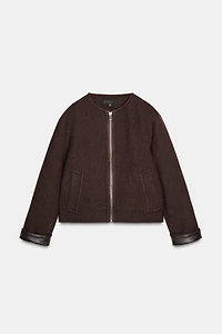 VESTE DOUCE AVEC FINITIONS EN MATIÈRE SYNTHÉTIQUE