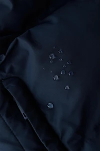 BLOUSON MATELASSÉ À CAPUCHE DÉPERLANT