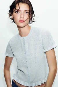 VESTE EN MAILLE STRUCTURÉE À VOLANTS