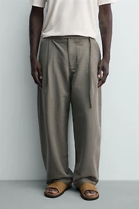 BALLOON FIT PLEATED BELTED PANTS