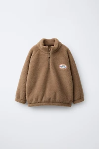 FAUX SHEARLING LABEL SWEATSHIRT