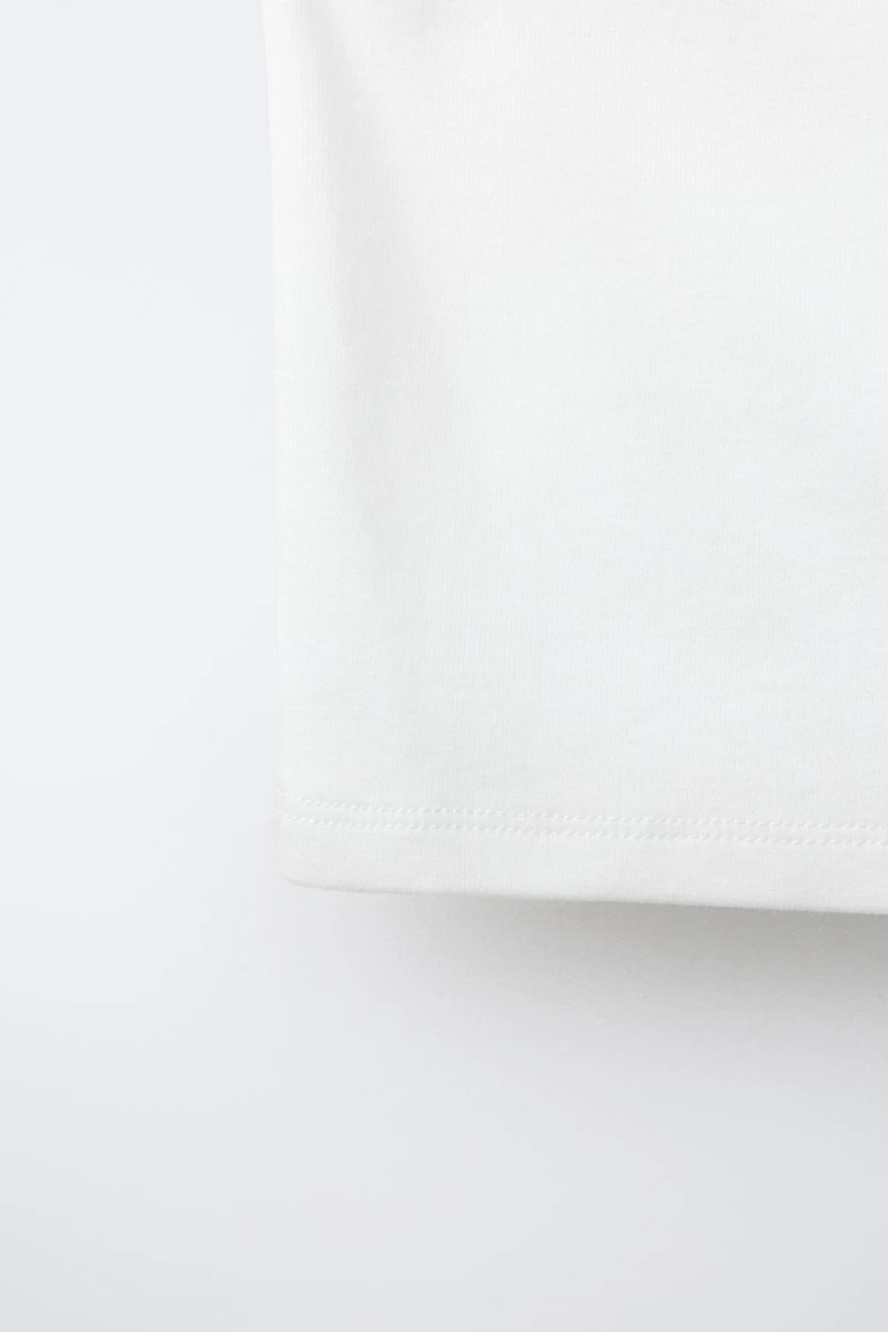 ASYMMETRIC BUCKLE TOP