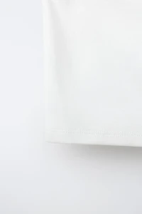 ASYMMETRIC BUCKLE TOP