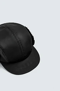 TECHNICAL CAP WITH SHEARLING EAR FLAPS