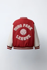 CLOTH BOMBER JACKET WITH FAUX LEATHER SLEEVES AND PATCHES