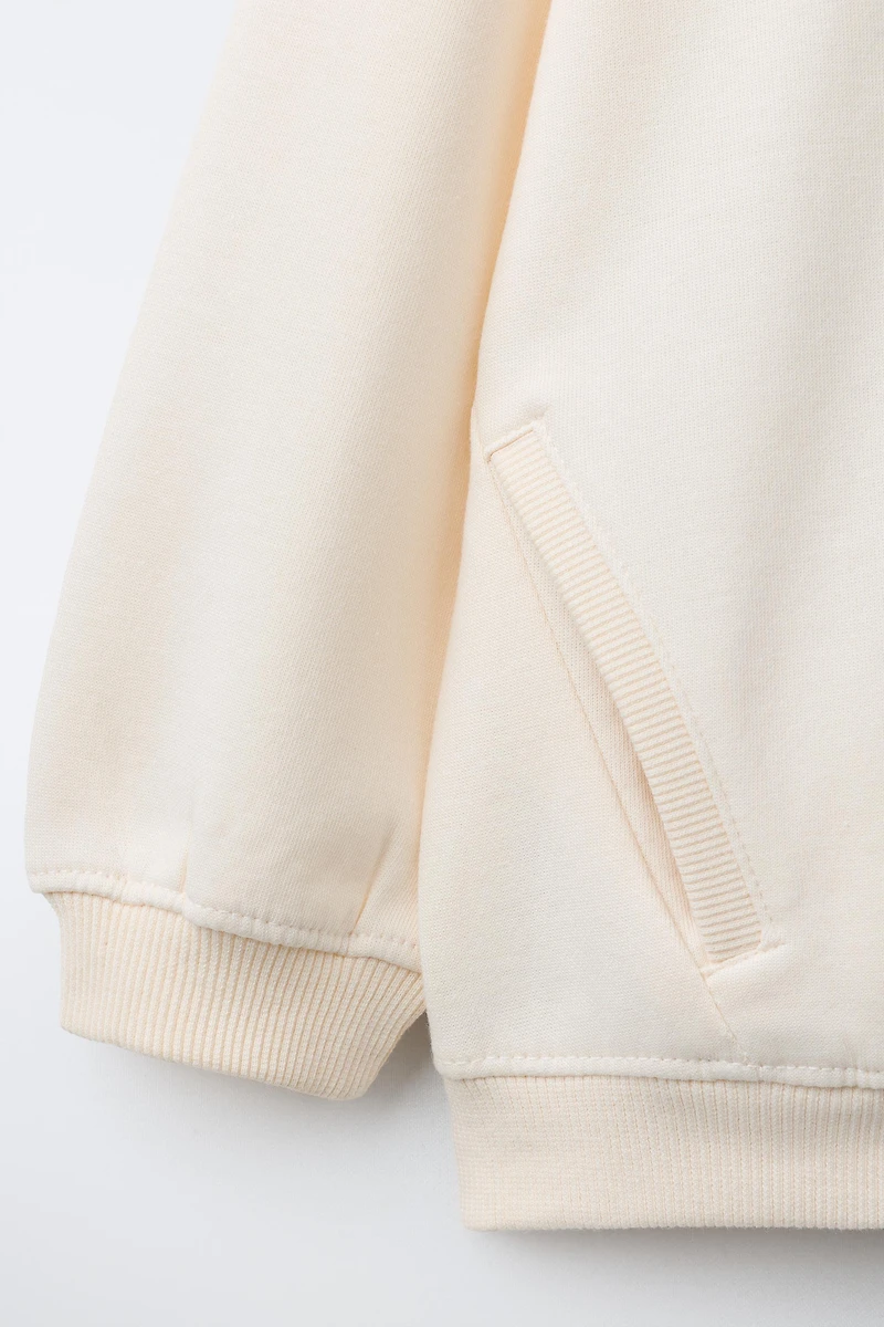 INTERLOCK ZIP SWEATSHIRT WITH RAISED TEXT