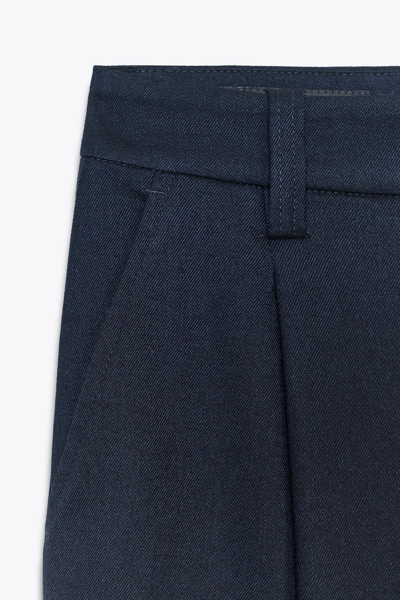 PLEATED PANTS WITH BUTTONED HEM