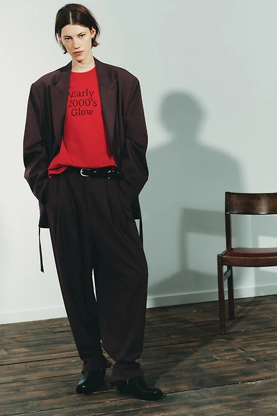 PLEATED PANTS WITH BUTTON HEM