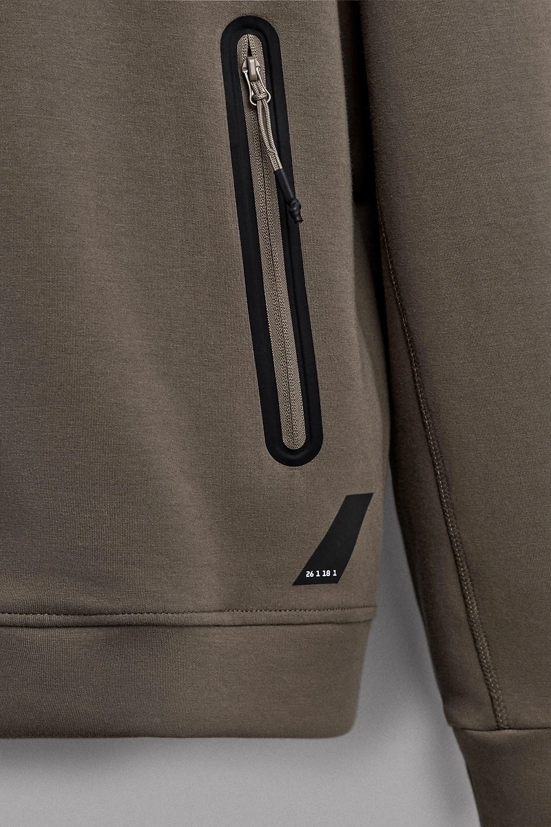 SWEAT TECHNIQUE ZIPPÉ À CAPUCHE