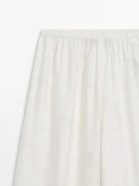 Flowing stretch trousers with fabric detail