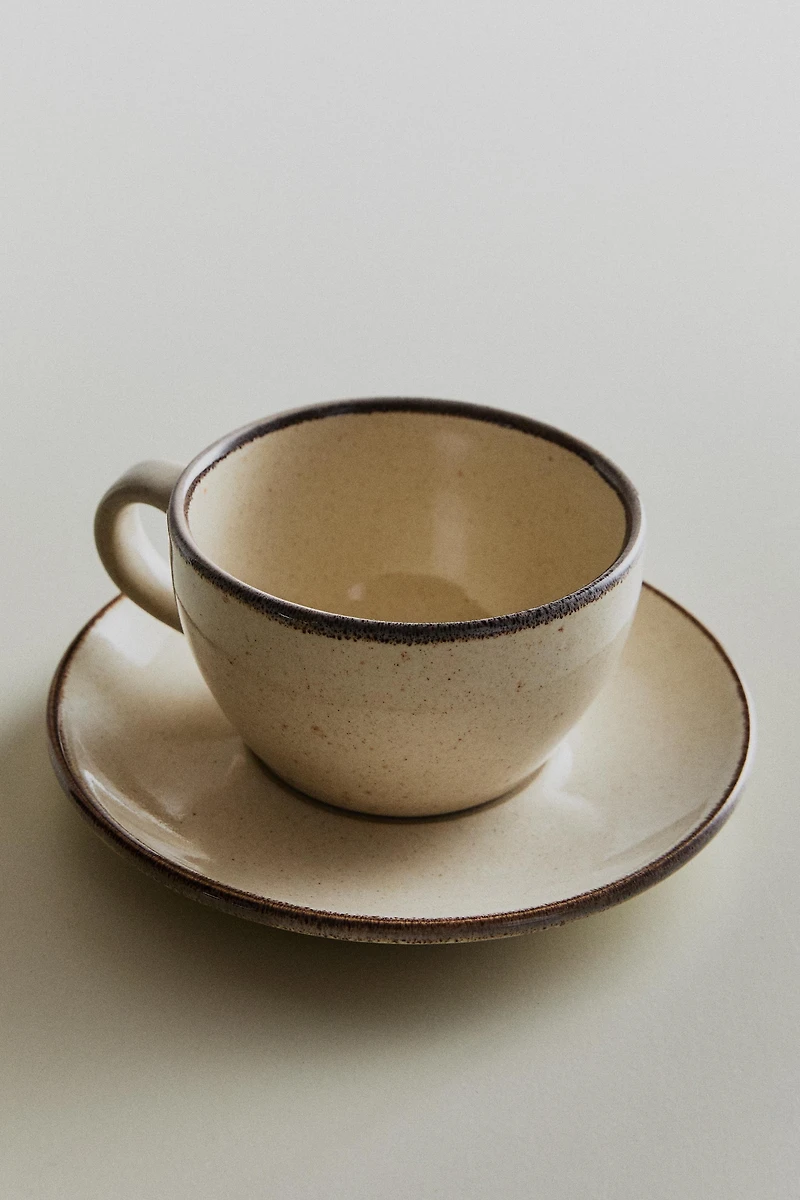 STONEWARE TEACUP AND SAUCER