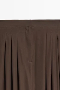 Flowing midi skirt with pleat detail