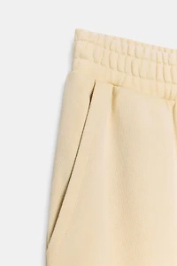 WASHED EFFECT FLEECE PANTS WITH STUDS